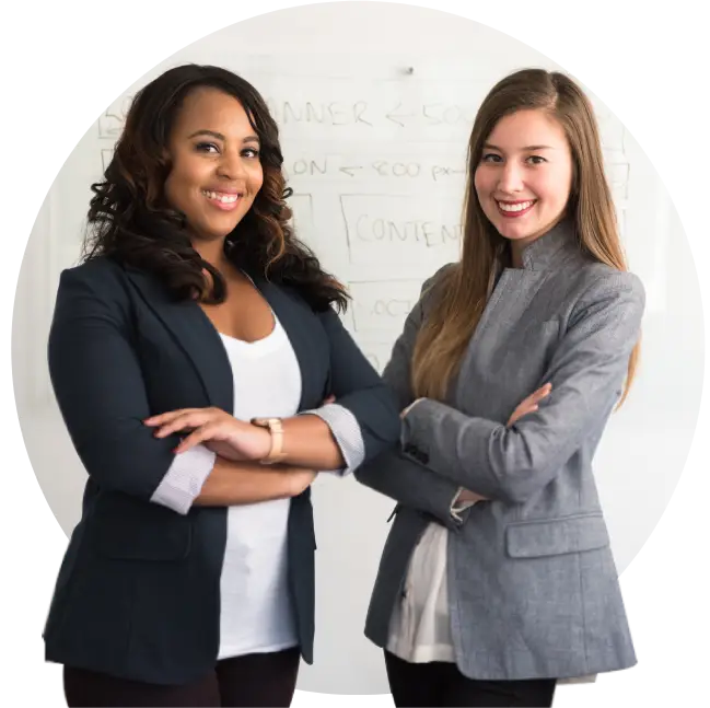 Two women standing next to each other with their arms crossed.